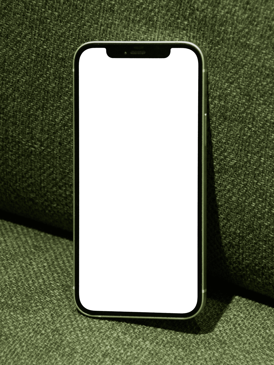 A personalised Momeo digital memento on an iPhone, resting on a green sofa.