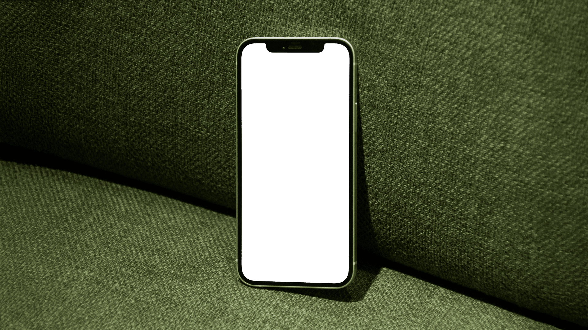 A personalised Momeo digital memento on an iPhone, resting on a green sofa.
